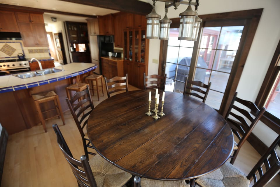 Dining room with 10 chairs and 3 barstools