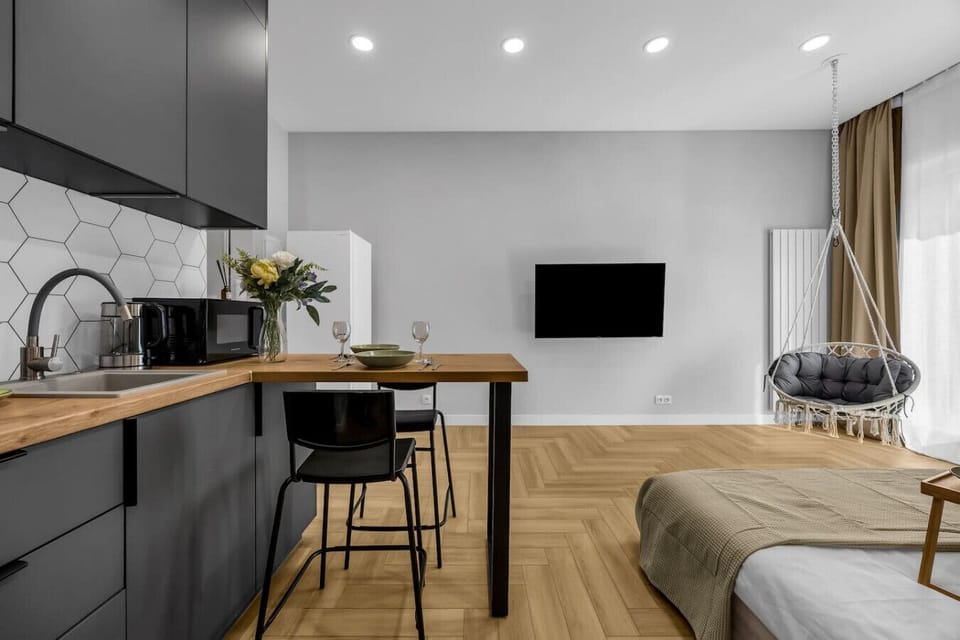 Modern Kitchen Area – Fully equipped with stove, microwave, kettle, and dining bar for two | Book Now with RENTUJEMY.COM
