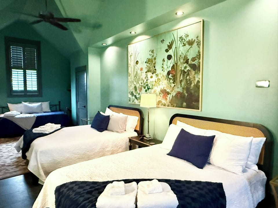 Third floor loft hosts two queen beds / two twin beds, walk-in closets & bath.