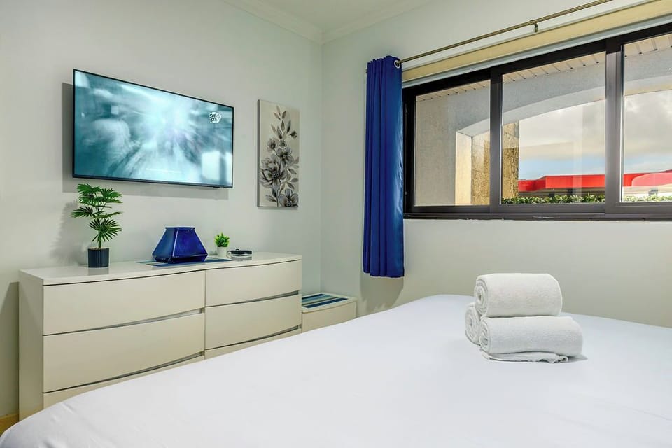 Enjoy your favorite shows from bed on the large, wall-mounted flat-screen TV.