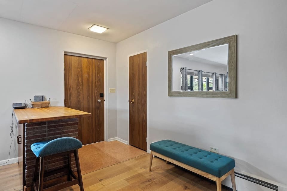 Stylish sitting area with a mirror create a relaxing space to unwind!