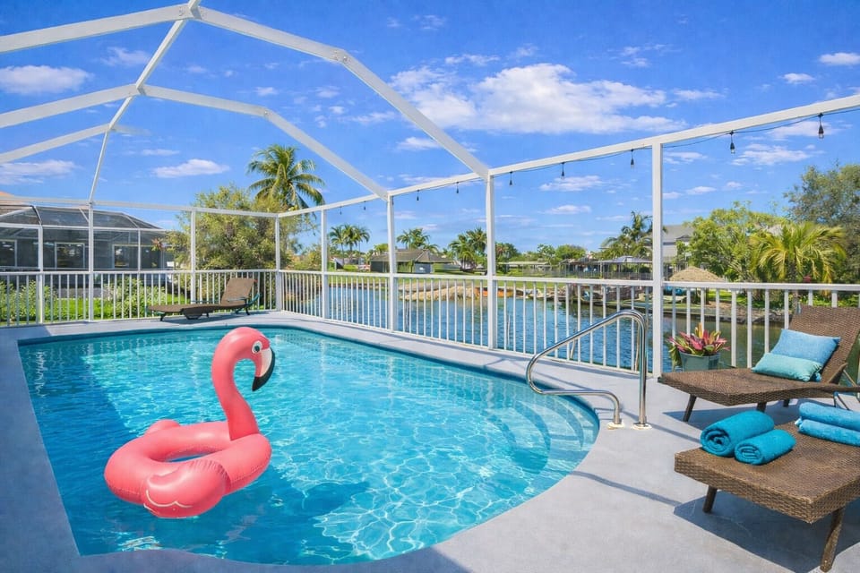 Solar heated screened pool overlooking serene gulf canal