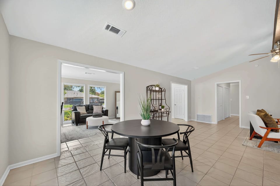 Dining Area: Enjoy meals at a stylish round table beneath charming light fixtures!