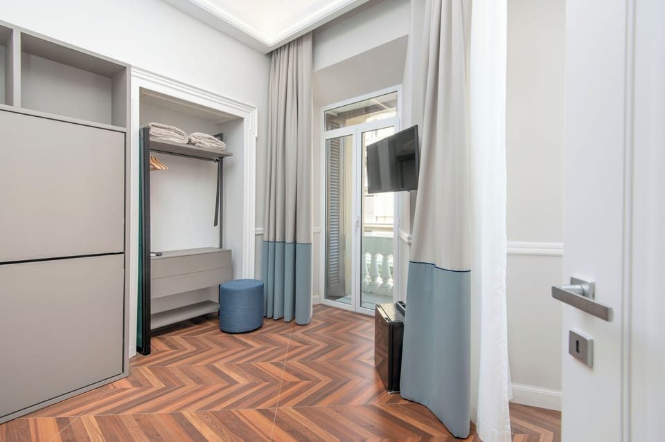 Family Suite, Balcony, City View | Minibar, in-room safe, desk, laptop workspace