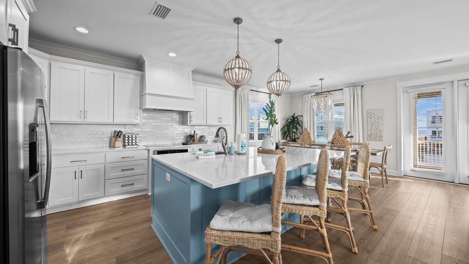 Fully stocked kitchen with large island for extra seating.