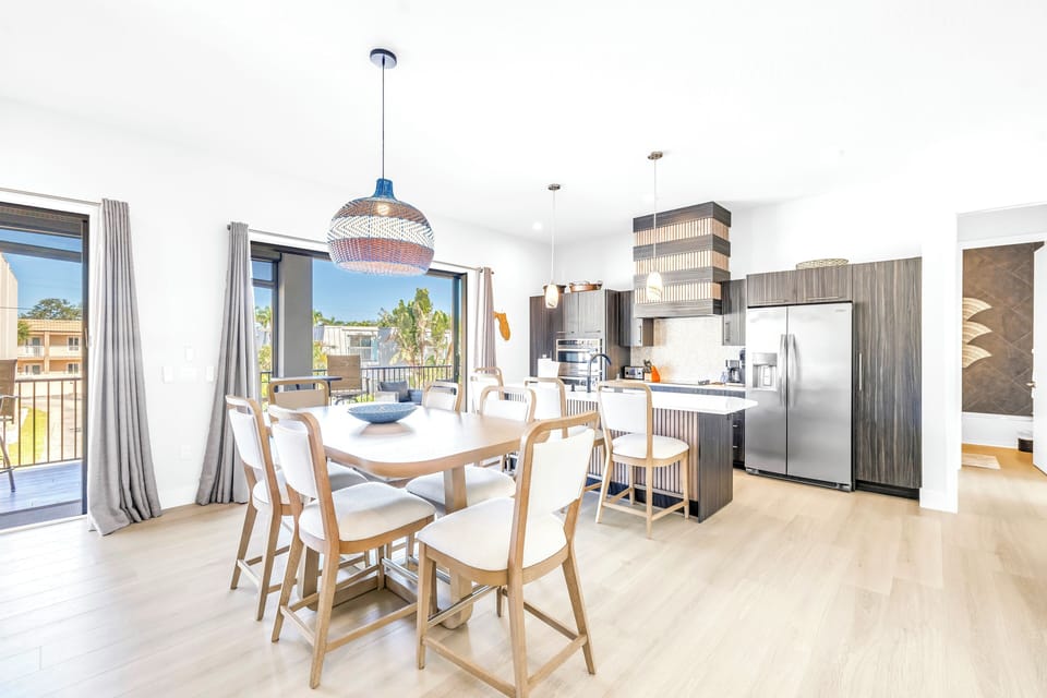 Dining table and bar island next to kitchen.