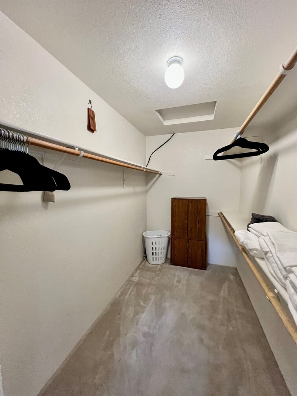 The spacious walk-in closet offers ample hanging space and convenient shelving to keep your belongings organized throughout your stay.