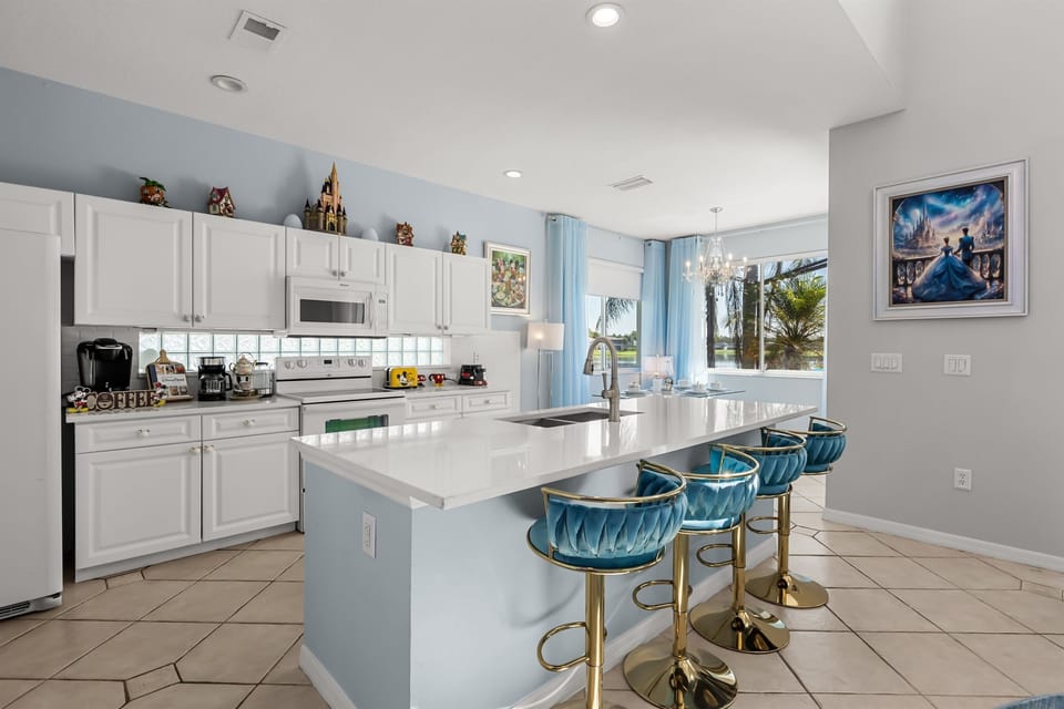 Ariel’s Ocean Kitchen – A fully equipped kitchen with sea-inspired accents and modern island seating.