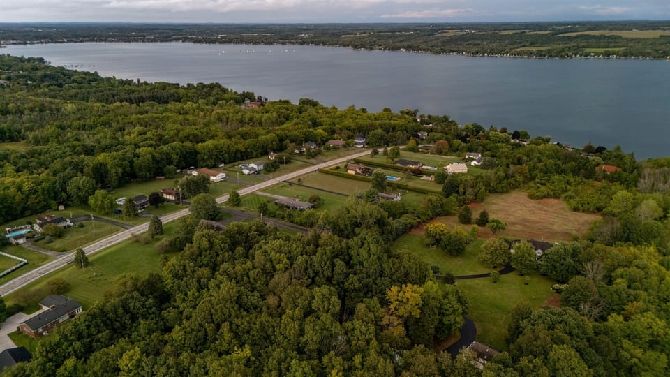 Stunning aerial view showcasing the serene beauty of the lake, lush greenery, and peaceful surrounding neighborhood. Perfect for highlighting location and natural setting.