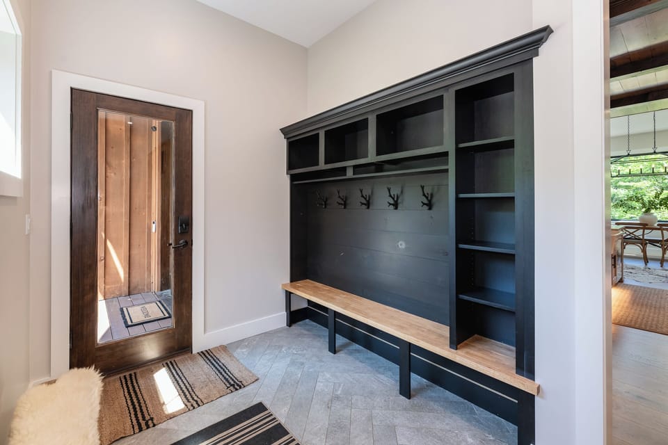 Spacious mudroom with built-in cubbies, coat hooks, and a bench. Perfect for organizing gear and keeping everything tidy after a day of adventure.