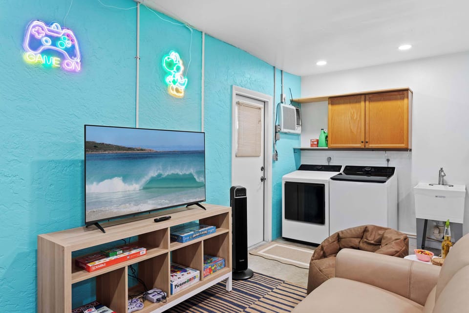 Amazing game room with pool table, ping pong, Pac-Man, Golden Tee, Nintendo Classic, board games and exercise equipment.