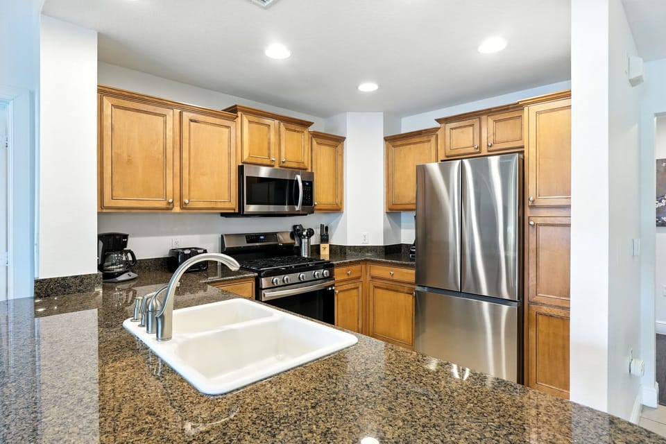 Sleek and functional—this kitchen features a modern countertop sink, perfect for cooking, cleaning, and entertaining with ease.