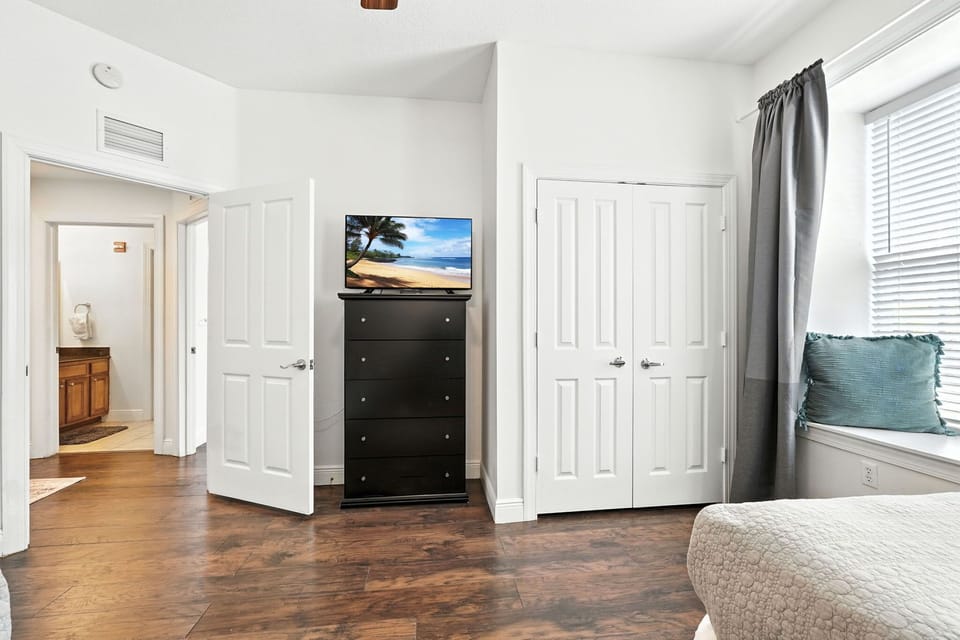 A spacious, relaxing bedroom featuring TV for cozy entertainment.