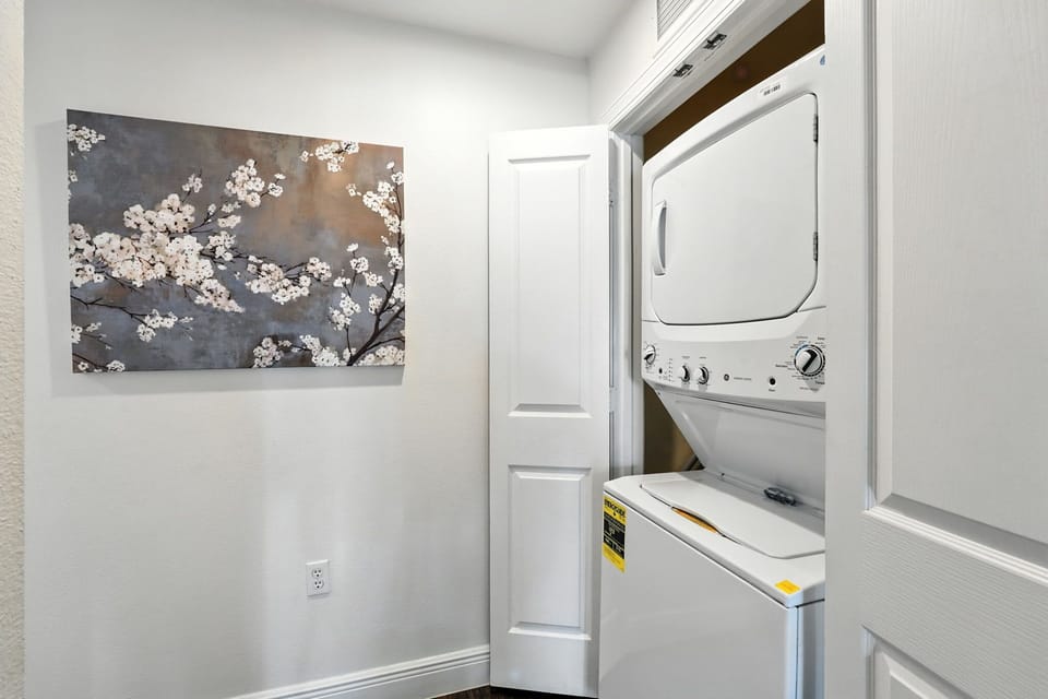 A clean, bright white laundry area designed for effortless chores and everyday convenience.