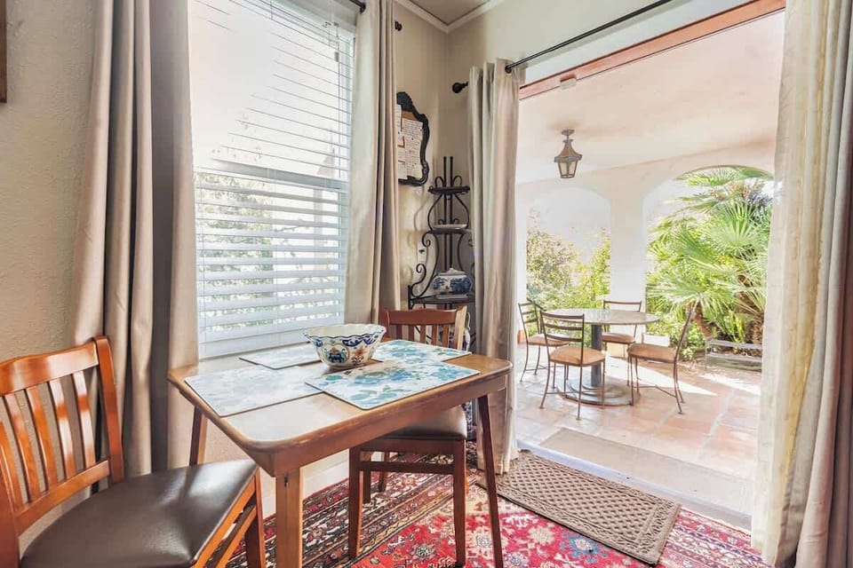 Enjoy your morning coffee at this cozy dining nook, filled with natural light and offering easy access to a bright patio space.