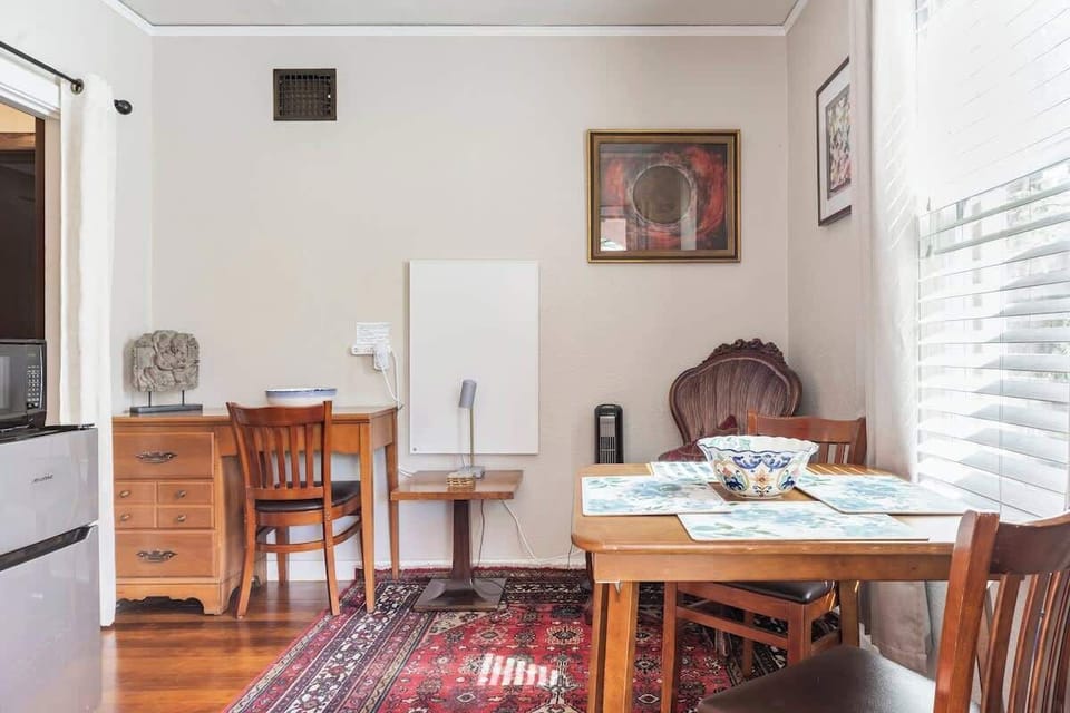 Inviting dining space with charming decor and a small workspace, ideal for relaxing breakfasts or planning the day ahead.