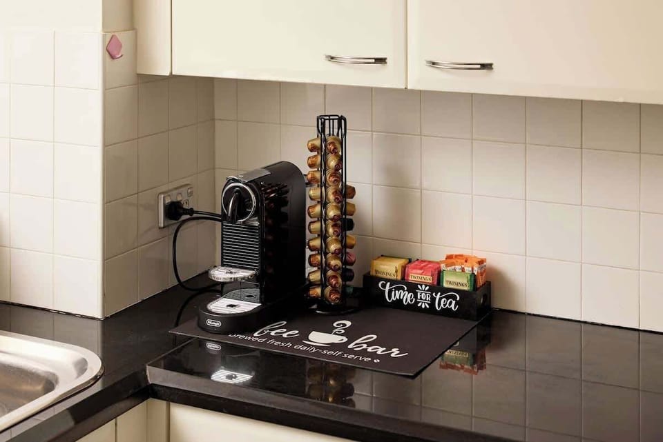 Premium coffee station with Nespresso machine, variety of pods and tea selection. Complete with capsule holder and welcome amenities for perfect morning brew in your George Street apartment.