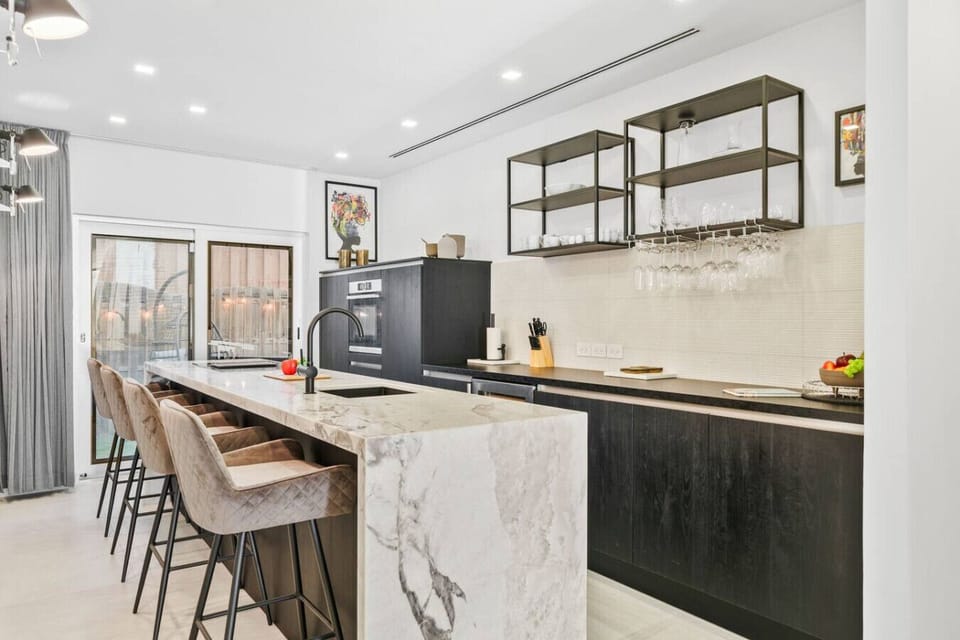 Modern kitchen with breakfast bar, oven and coffee maker