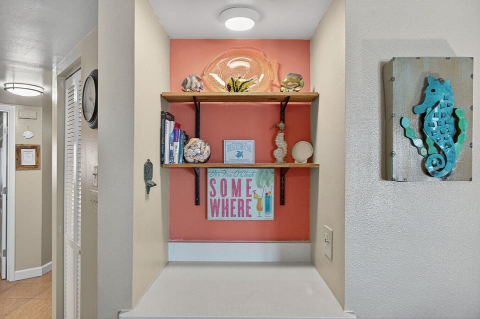Fun accent nook w/ colorful decor and shelving that adds personality to the space.