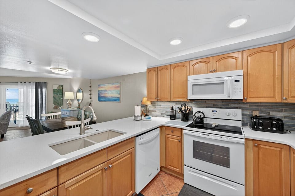 Fully equipped kitchen w/ ample counter space and bar seating for casual meals.