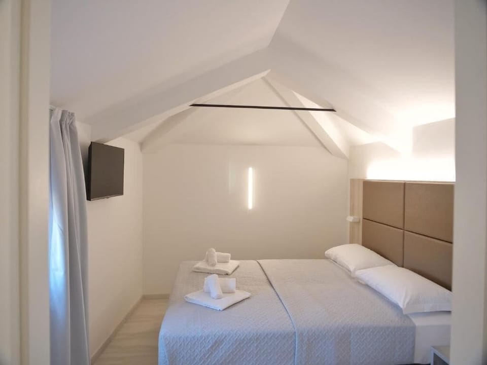 Deluxe Quadruple Room, City View | Desk, laptop workspace, free WiFi