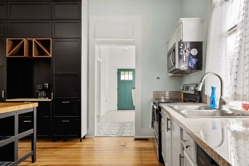 A bright kitchen leads to a charming entryway with natural light and modern upgrades. It’s a clean, practical space designed for easy cooking and daily comfort.