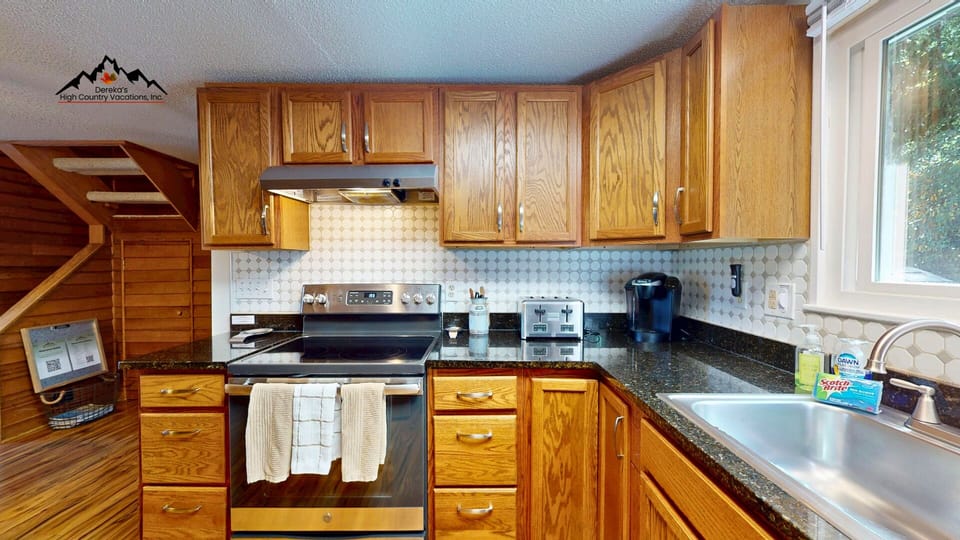 Fully equipped kitchen with modern appliances, ample counter space, and everything needed for cooking meals at home. Clean, functional, and ideal for group or family stays.