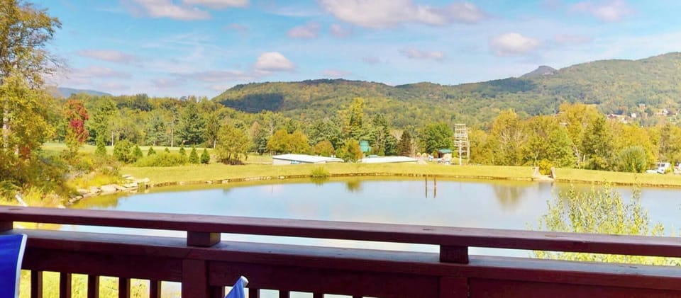 Main deck with seating and peaceful views of the lake, golf course, and surrounding mountains. Perfect for morning coffee or evening relaxation.