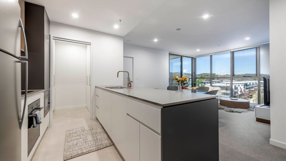 Sleek kitchen flowing into lounge