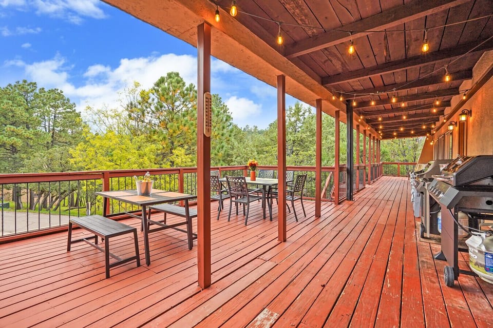 Spacious Covered Deck | Outdoor Dining & Grilling Area | Surrounded by Lush Pine Trees
