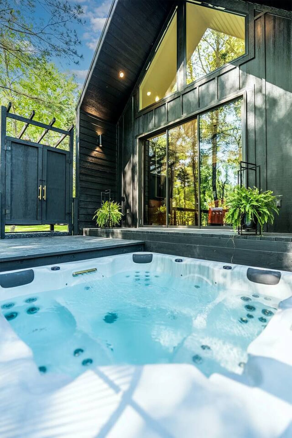 Secluded outdoor hot tub located on a private deck in a wooded setting.