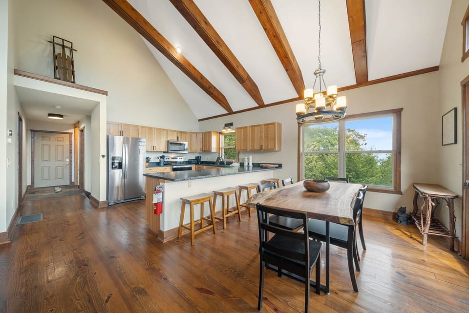 Raw Edge Wood Dining Table and Kitchen Bar Seating Provides Space for 10 Diners