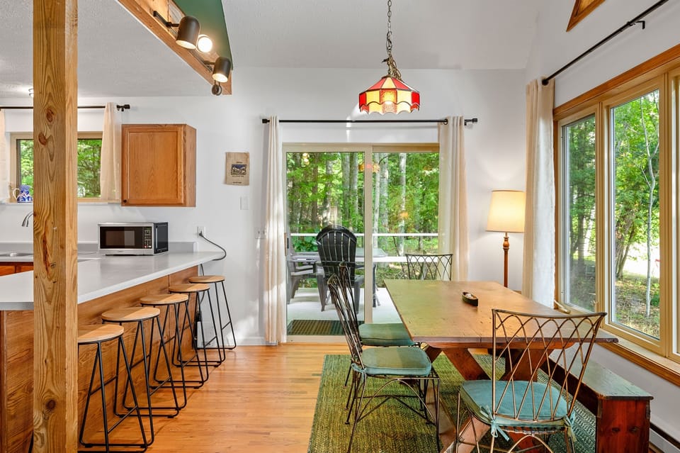 Dining area and kitchen with walk-out access to the deck