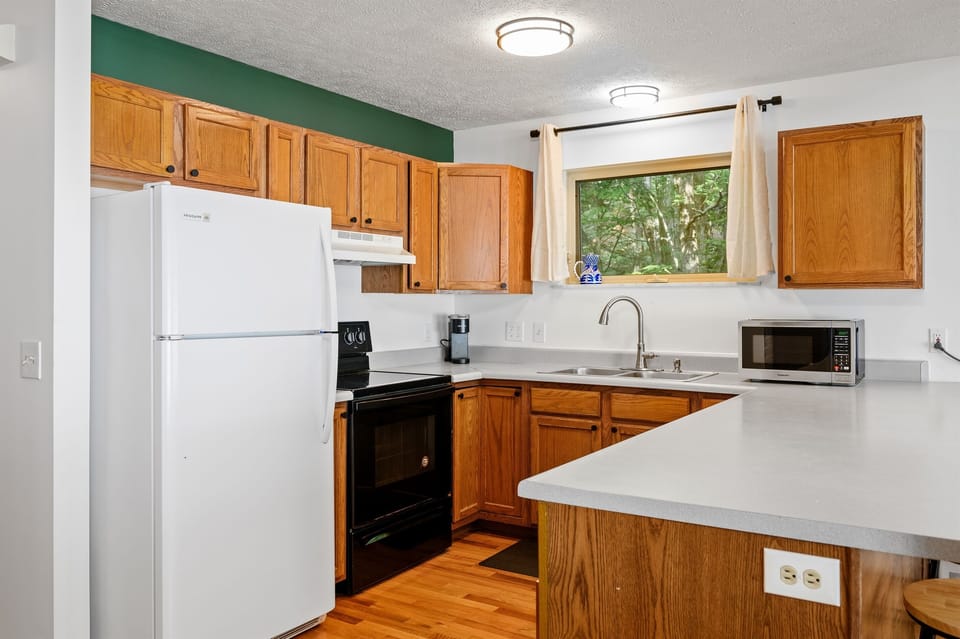 Fully equipped kitchen with appliances and window light