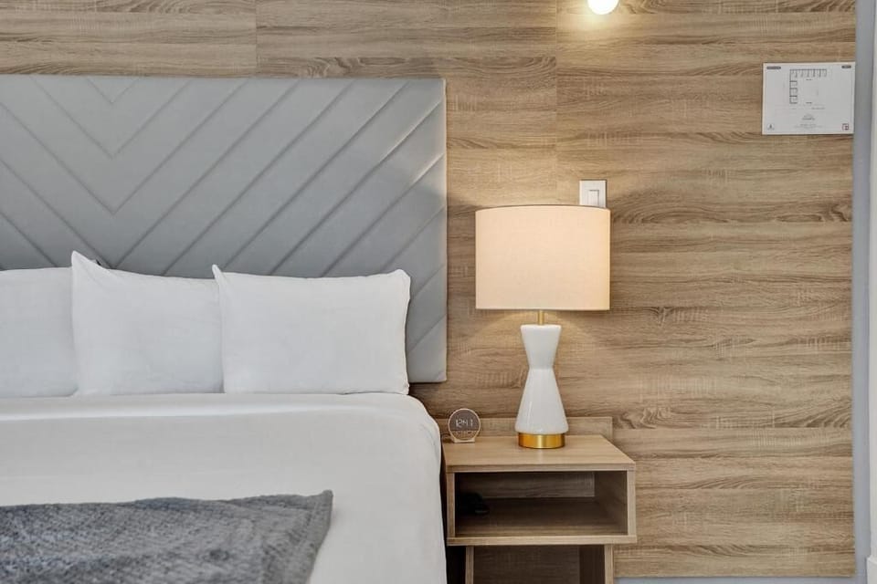 Drift off under soft lamplight and a plush headboard.