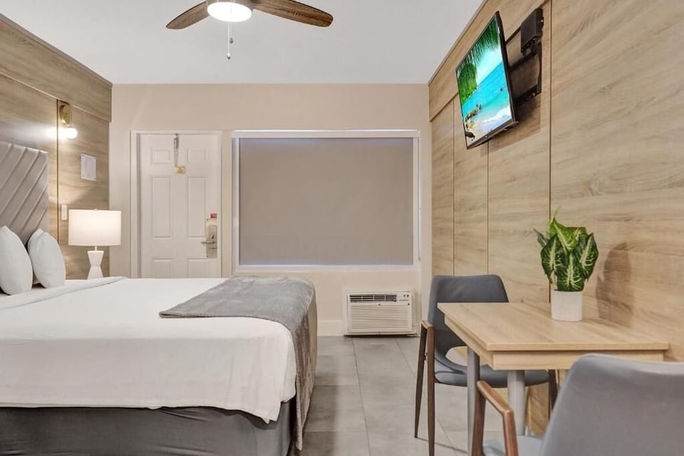 Unwind in crisp linens with a cozy in-room dining nook.