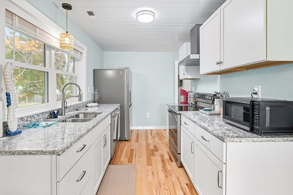 Kitchen: Gourmet kitchen with granite countertops, stainless steel appliances, and a commercial-grade vented hood.