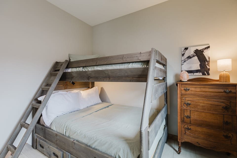 The second bedroom includes a twin-over-full bunk bed