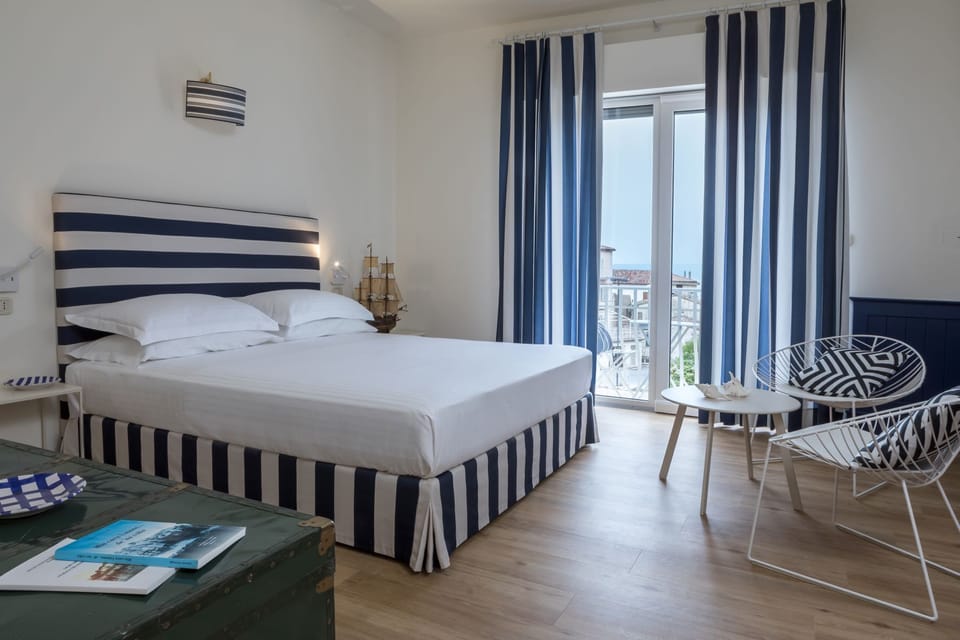 Family Room, Sea View | Down comforters, minibar, in-room safe, desk