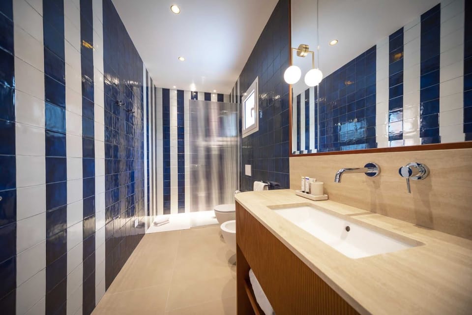 Family Suite, Sea View | Bathroom | Shower, free toiletries, hair dryer, slippers