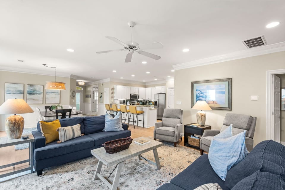Sink into plush navy sofas and gray armchairs in your spacious open-concept living area.