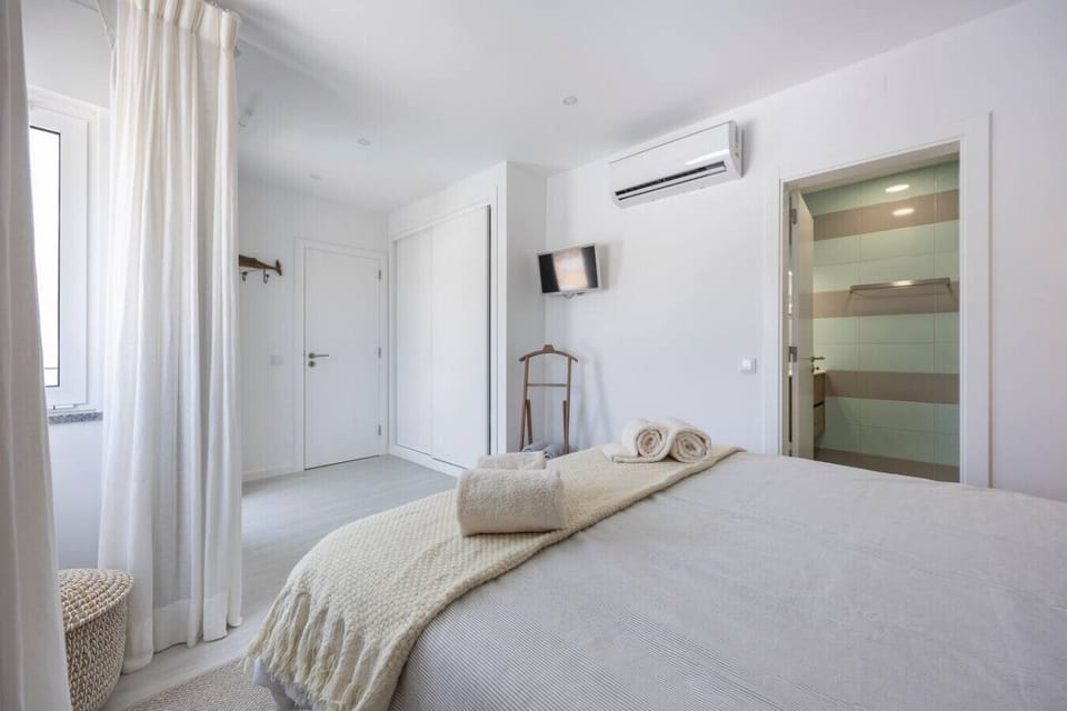 Main bedroom with double bed and ensuite bathroom.