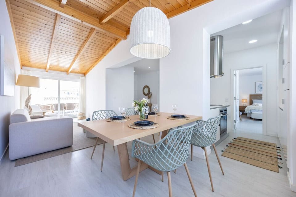 Dining area with view onto living room and primary bedroom.