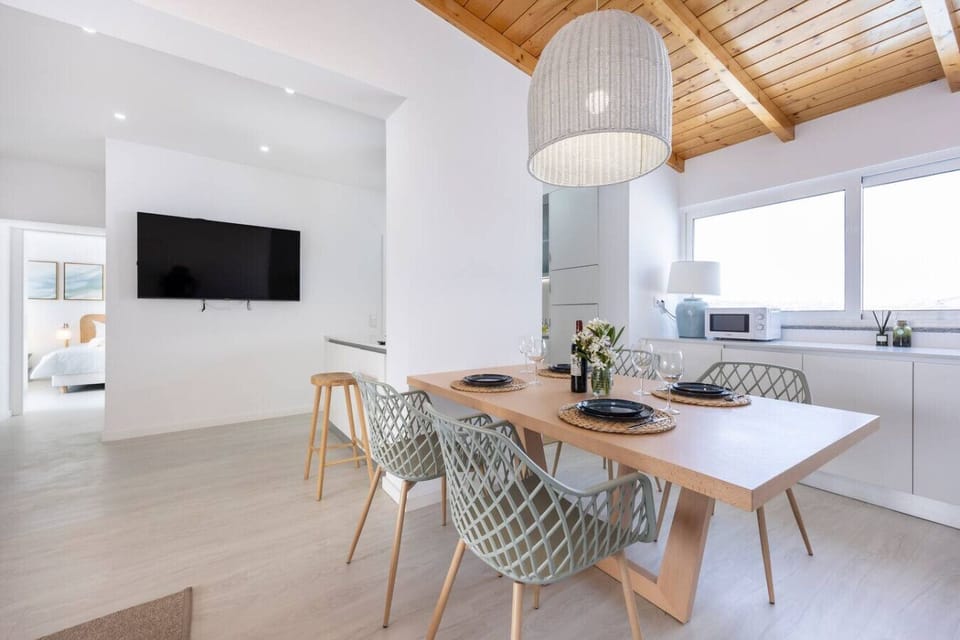 Dining area with view into kitchen and the second bedroom.