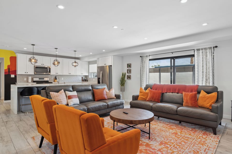 Spacious lounge with smart TV and vibrant accents.