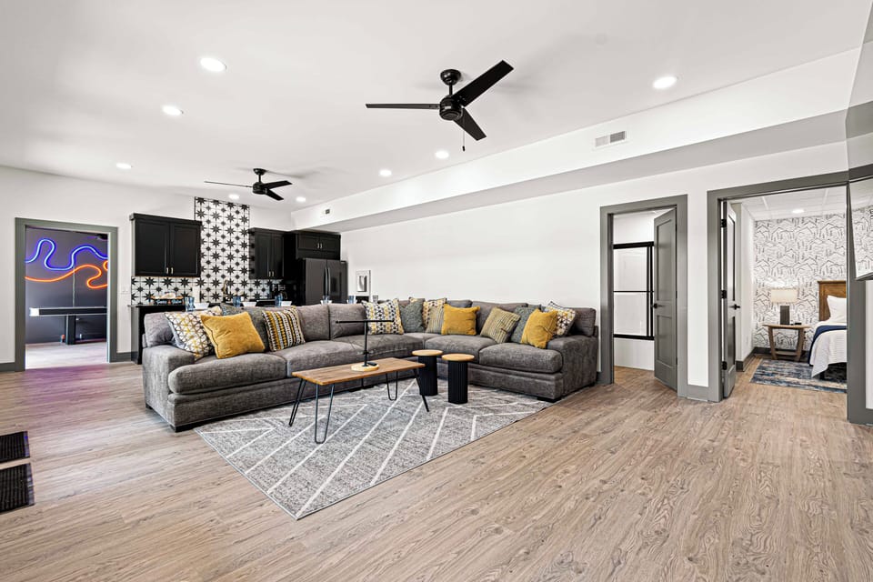 Spacious living area with sleek design and cozy sectional seating.