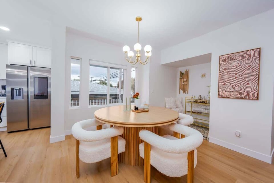 Gorgeous Bar cart area with Modern accents. Chandeliers throughout the dining area. Lighting galore for a perfect mood in any lighting. Iconic chairs and furnishings. Bright tribal accents throughout. 