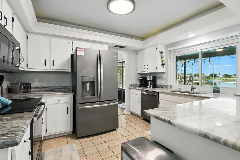 Kitchen island provides more counter space and is open to breakfast nook and family room