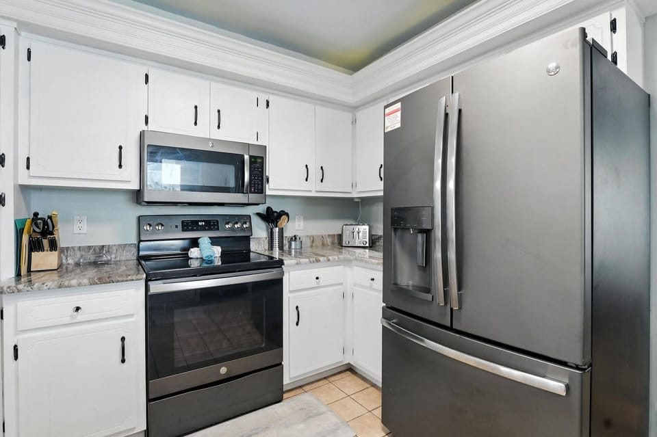 Ice & water dispenser, electric flat top stove. All kitchen amenities you will need to cook great meals together