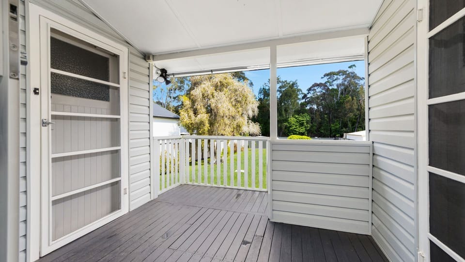 Welcoming front porch with a relaxing outlook.